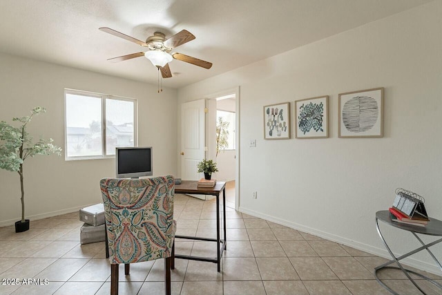 office area featuring light tile patterned floors, a ceiling fan, and baseboards