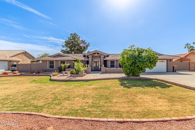 ranch-style home with a garage and a front yard