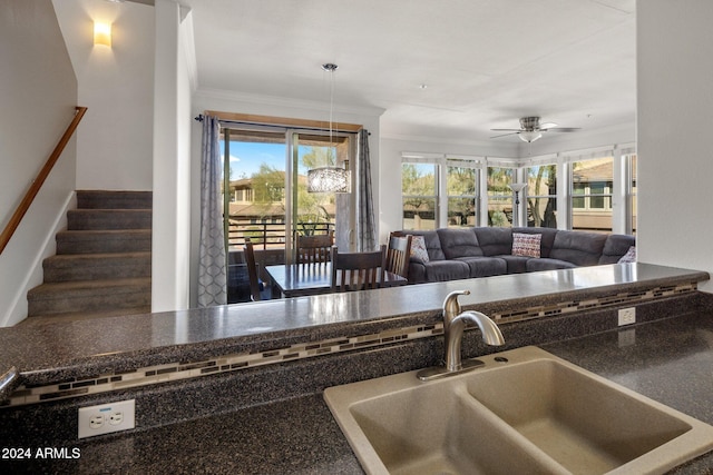 kitchen with ceiling fan, ornamental molding, and sink