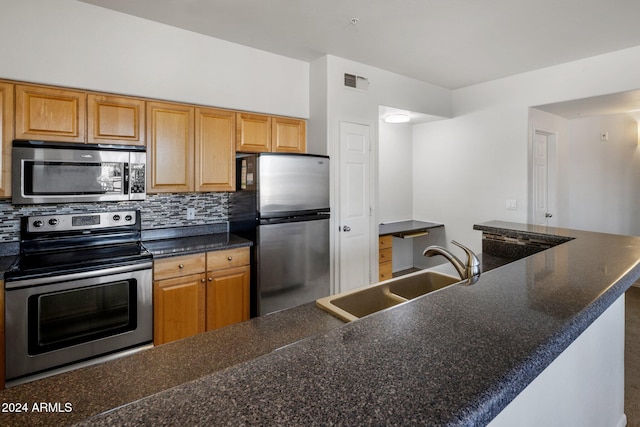 kitchen with decorative backsplash, sink, a center island, and appliances with stainless steel finishes