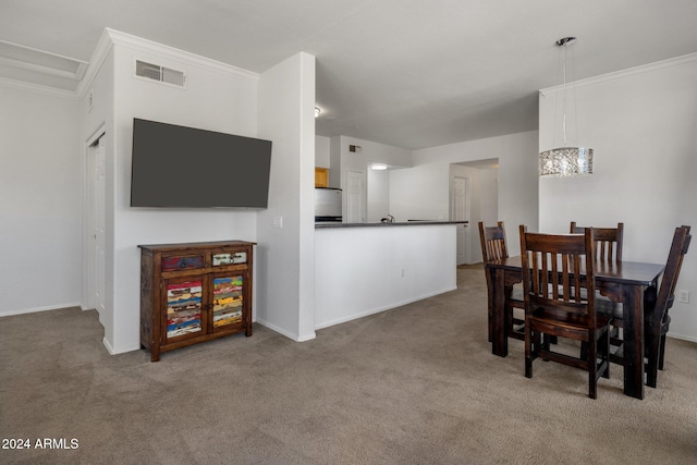 dining area with a chandelier, carpet floors, and ornamental molding