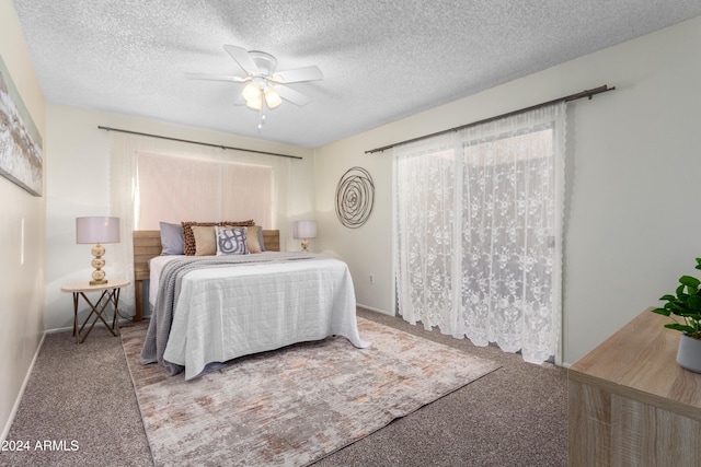 bedroom with carpet, ceiling fan, and a textured ceiling