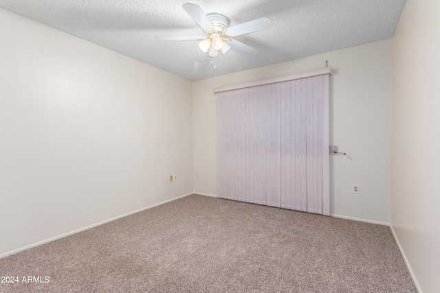 unfurnished room featuring carpet, ceiling fan, and a textured ceiling