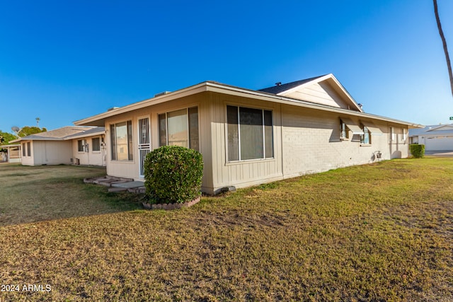 view of side of property with a yard