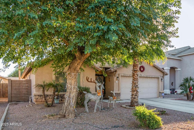 view of property hidden behind natural elements with a garage