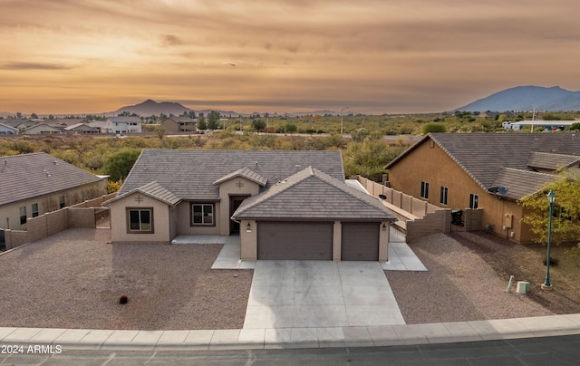 view of front of house with a mountain view and a garage