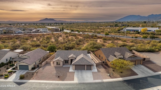 aerial view at dusk featuring a mountain view