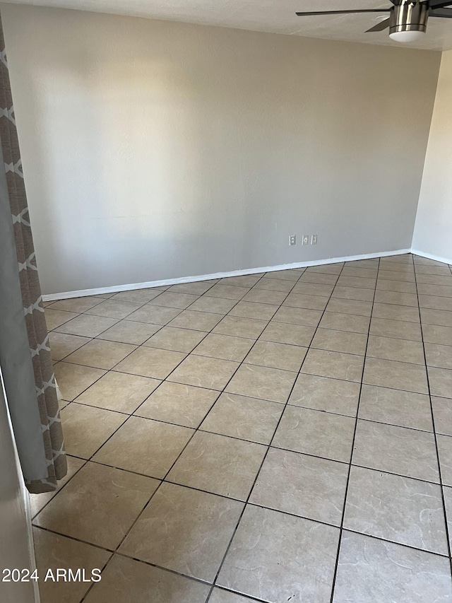 empty room with tile patterned flooring and ceiling fan