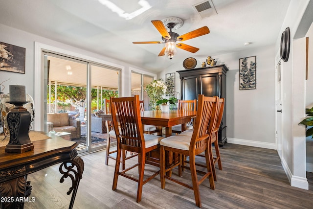 dining space with ceiling fan, dark hardwood / wood-style floors, and lofted ceiling