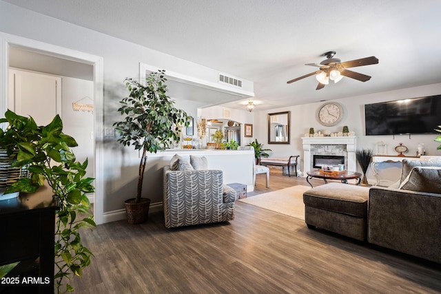 living room with ceiling fan and wood-type flooring