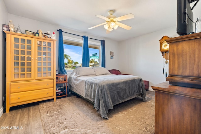 bedroom with hardwood / wood-style floors and ceiling fan