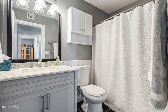 bathroom with tile patterned floors, vanity, and toilet