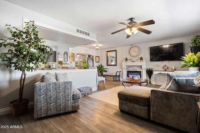 living room featuring hardwood / wood-style flooring and ceiling fan