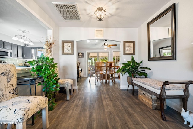 hall featuring a notable chandelier and dark hardwood / wood-style flooring