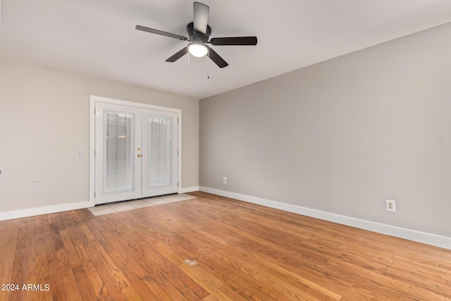 unfurnished bedroom with ceiling fan, light hardwood / wood-style flooring, and french doors