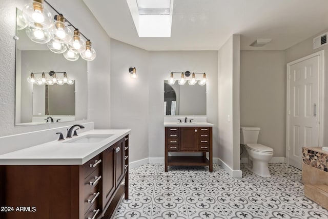 bathroom featuring tile patterned floors, vanity, and toilet