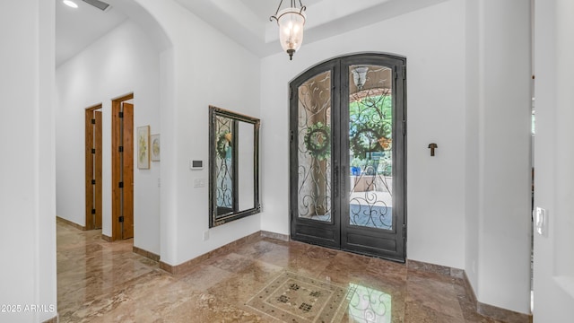 7130 E Saddleback St Unit 58, Mesa, AZ 85207 - entrance foyer featuring arched walkways, french doors, baseboards, and a high ceiling