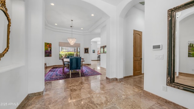 7130 E Saddleback St Unit 58, Mesa, AZ 85207 - hallway featuring arched walkways, baseboards, recessed lighting, a raised ceiling, and marble tiled floors