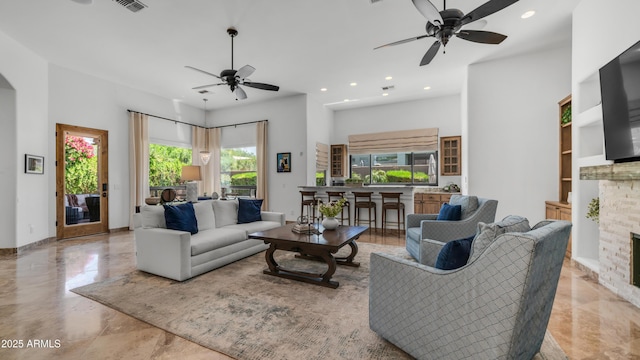 7130 E Saddleback St Unit 58, Mesa, AZ 85207 - living room featuring ceiling fan, a fireplace, recessed lighting, and built in features