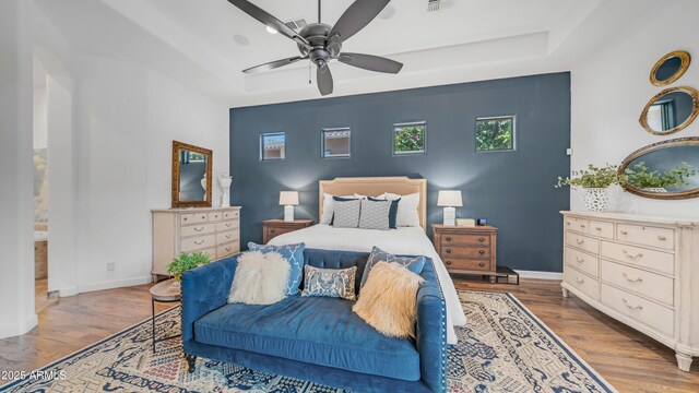 7130 E Saddleback St Unit 58, Mesa, AZ 85207 - bedroom featuring a raised ceiling, wood finished floors, baseboards, and ceiling fan