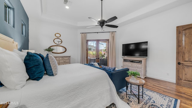 7130 E Saddleback St Unit 58, Mesa, AZ 85207 - bedroom featuring a raised ceiling, wood finished floors, baseboards, and a ceiling fan