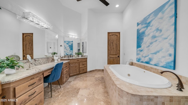 7130 E Saddleback St Unit 58, Mesa, AZ 85207 - bathroom with a towering ceiling, a whirlpool tub, vanity, ceiling fan, and stone finish flooring