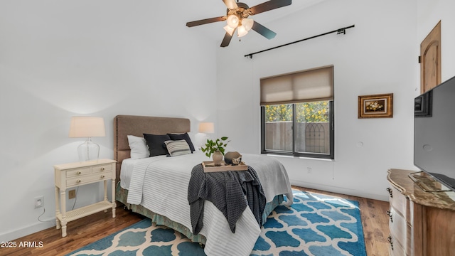 7130 E Saddleback St Unit 58, Mesa, AZ 85207 - bedroom with wood finished floors, baseboards, ceiling fan, and a towering ceiling