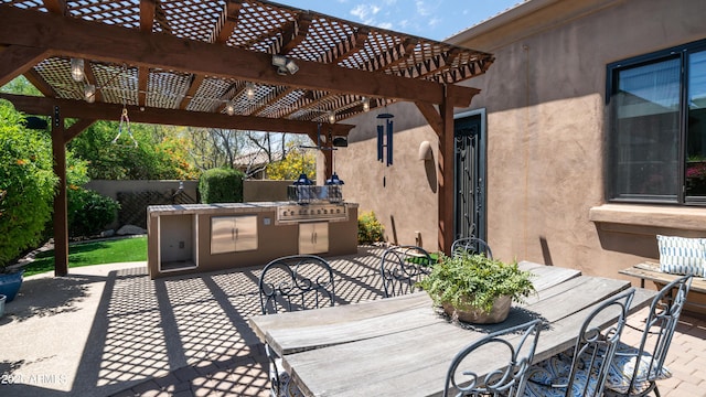 7130 E Saddleback St Unit 58, Mesa, AZ 85207 - view of patio / terrace with outdoor dining area, exterior kitchen, a pergola, and fence