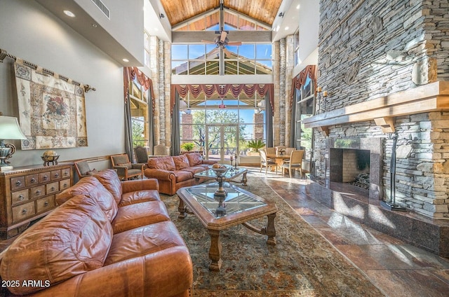 7130 E Saddleback St Unit 58, Mesa, AZ 85207 - living room featuring high vaulted ceiling, stone tile flooring, a fireplace, and recessed lighting