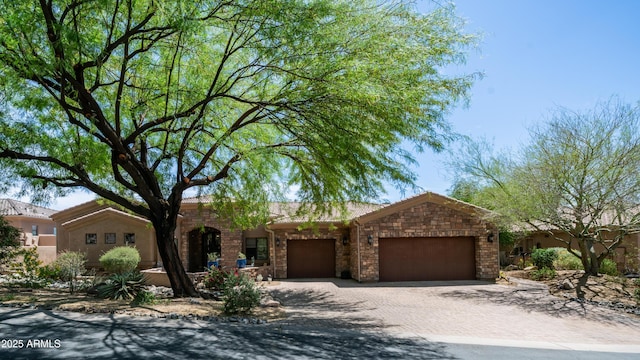 7130 E Saddleback St Unit 58, Mesa, AZ 85207 - ranch-style home with an attached garage, stone siding, and driveway