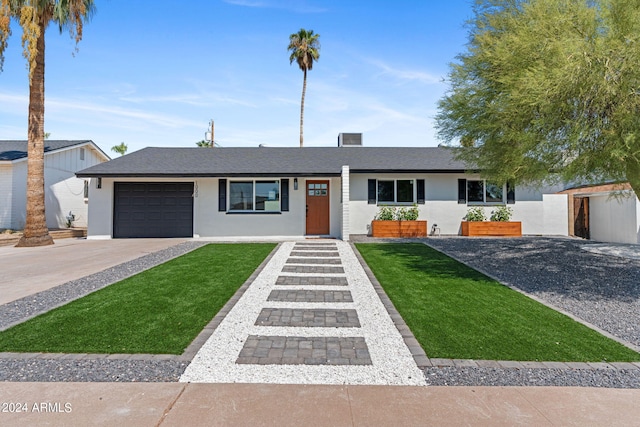 single story home featuring a garage and a front yard