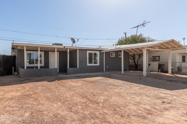 rear view of property featuring fence