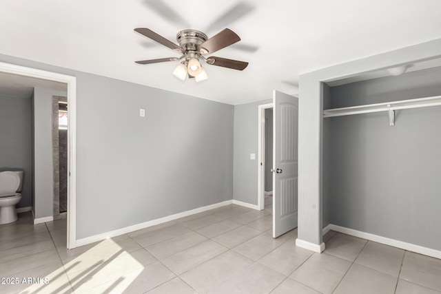 unfurnished bedroom featuring baseboards, a closet, and light tile patterned flooring