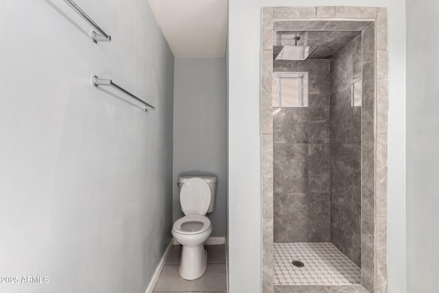 bathroom featuring a stall shower, tile patterned flooring, toilet, and baseboards