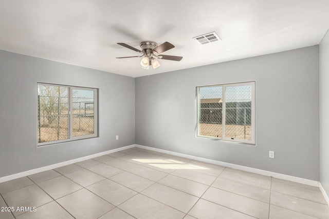 unfurnished room with plenty of natural light, visible vents, and baseboards