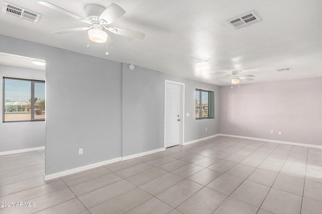 empty room with visible vents, plenty of natural light, and ceiling fan