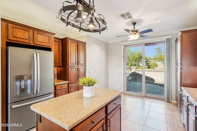 kitchen featuring hanging light fixtures, crown molding, a kitchen island, and stainless steel fridge