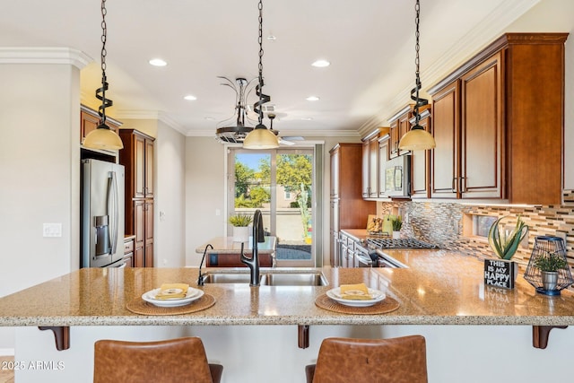 kitchen featuring pendant lighting, appliances with stainless steel finishes, and sink