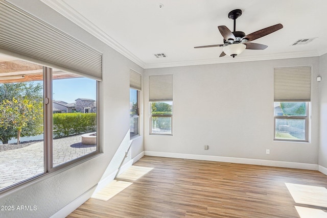 spare room featuring crown molding, ceiling fan, and light wood-type flooring