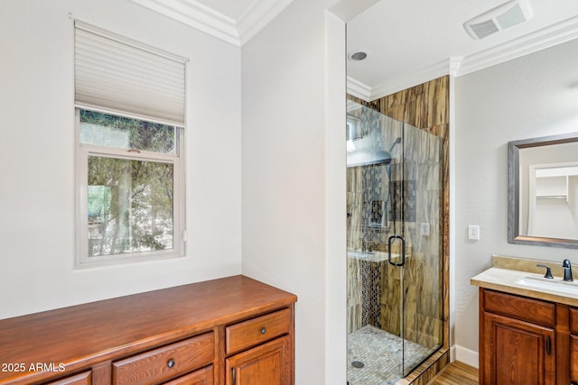 bathroom featuring vanity, crown molding, and walk in shower