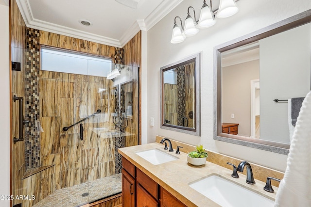 bathroom with crown molding, vanity, and a tile shower