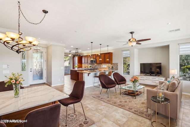 tiled living room with ornamental molding and a wealth of natural light