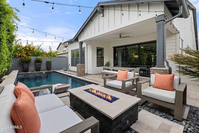 view of pool featuring a patio, ceiling fan, and an outdoor living space with a fire pit