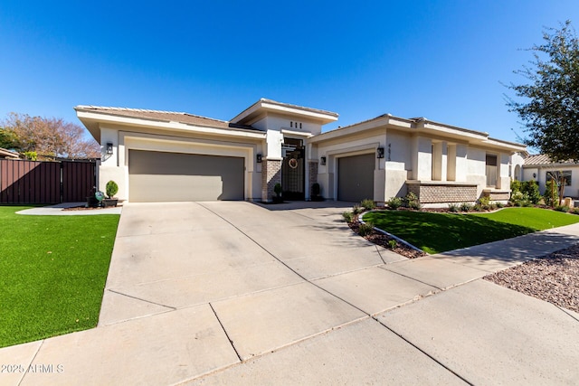 prairie-style house with a garage and a front lawn