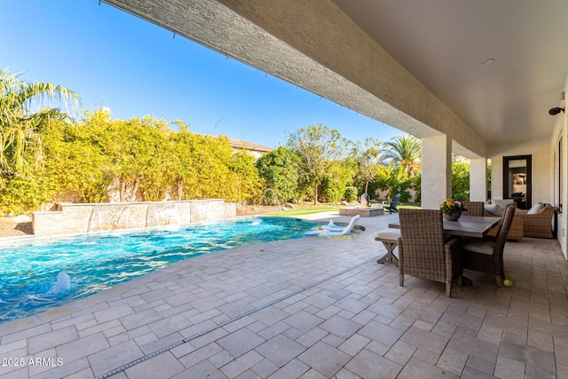 view of swimming pool with a patio and pool water feature