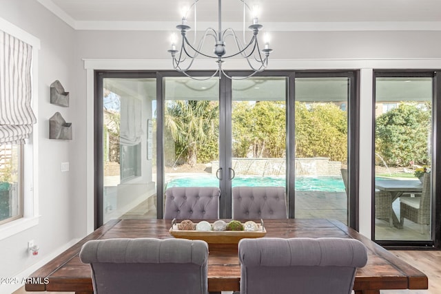 doorway featuring hardwood / wood-style flooring, ornamental molding, and a notable chandelier