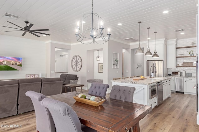 dining space featuring ornamental molding, sink, wood ceiling, and light wood-type flooring