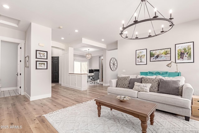 living room featuring a chandelier and light hardwood / wood-style flooring