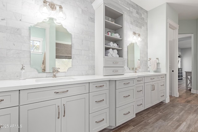 bathroom with vanity, hardwood / wood-style floors, and backsplash