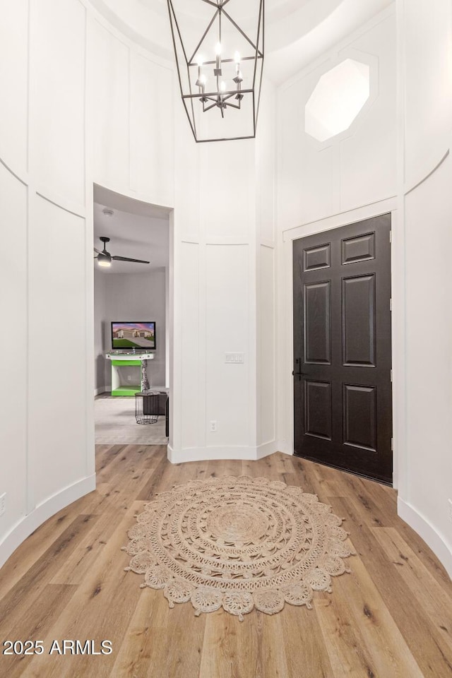 foyer entrance featuring an inviting chandelier and wood-type flooring